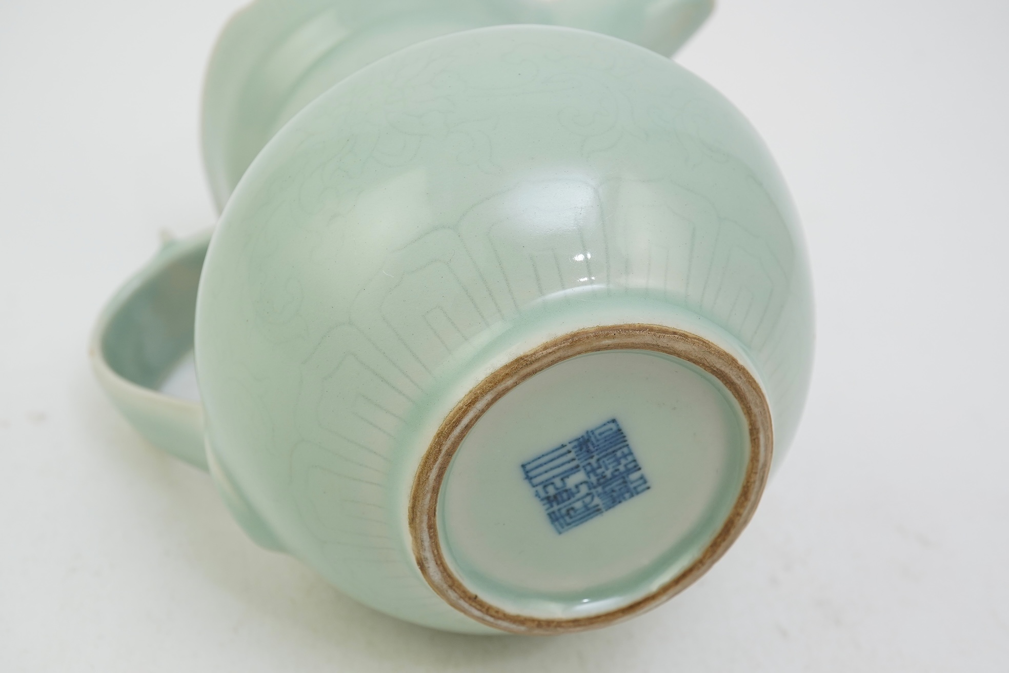 A Chinese incised celadon glazed monks cap ewer, Qianlong seal mark but later, 17cm